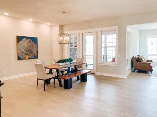 Photo from a similar home in another community. This shows the dining room area out to the screened porch. Awesome 10' main level ceilings! Colors will vary.