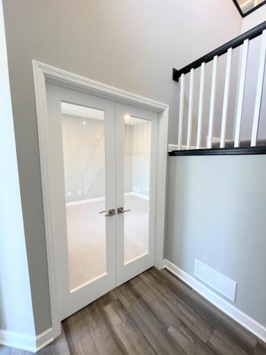 The natural light streams through the glassed French doors. Photos are of the actual home.