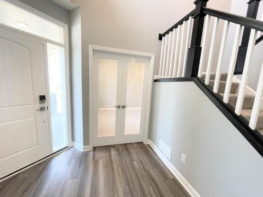 There is space for a front entry table below the staircase. Photos are of the actual home.
