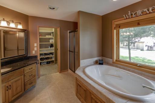 Primary bath with jetted tub and ceramic tile.