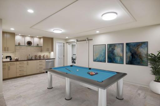 Lower level bar / game room area. Virtually Staged.