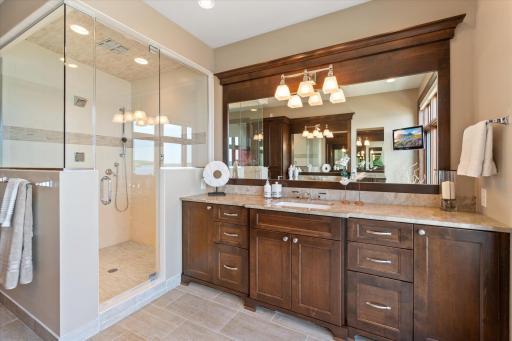 In floor heat, 9 head steam shower and two vanities in the private primary bath. Separate water closet.