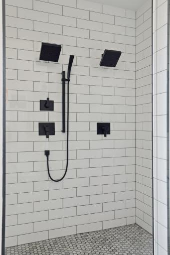 Walk-in, tiled, shower features dual shower heads