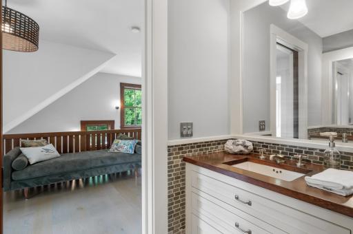 The bathroom boasts accent walls adorned with decorative tiles, adding visual interest and creating a focal point within the space.