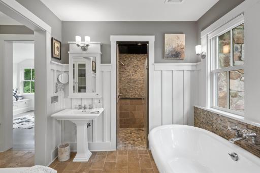 The bathroom floor is adorned with tiled flooring that incorporates a heating system. This provides a warm and comfortable surface to walk on, especially during colder seasons.