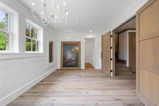 The walls of the bedroom are covered with wood shiplap, offering a rustic and charming look. The natural wood texture and horizontal paneling add warmth and character to the space, creating a cozy and inviting atmosphere.