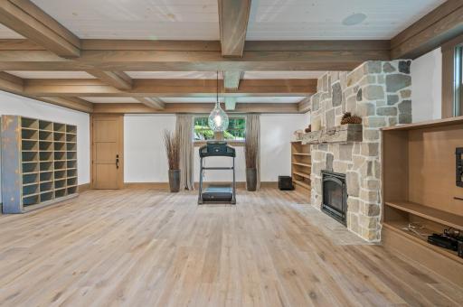 The family room showcases exposed beams on the ceiling, adding a rustic and charming touch to the space. These beams contribute to the architectural character of the room and create a warm and inviting atmosphere.