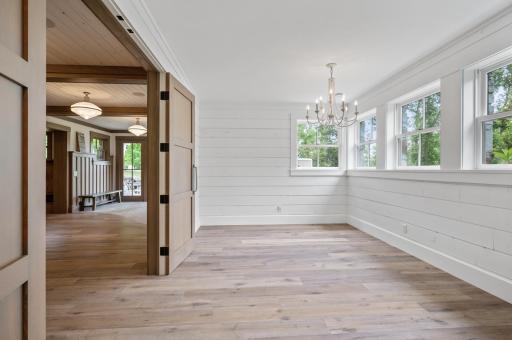 This lower-level bedroom combines the abundance of natural light from the four oversized windows with the elegance of a double door entry.