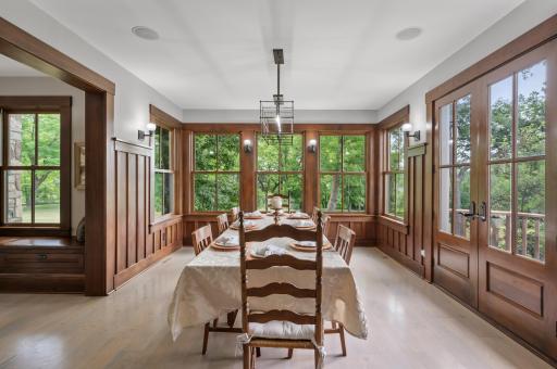 The formal dining room boasts numerous oversized windows, which flood the space with natural light and offer picturesque views of the surroundings.