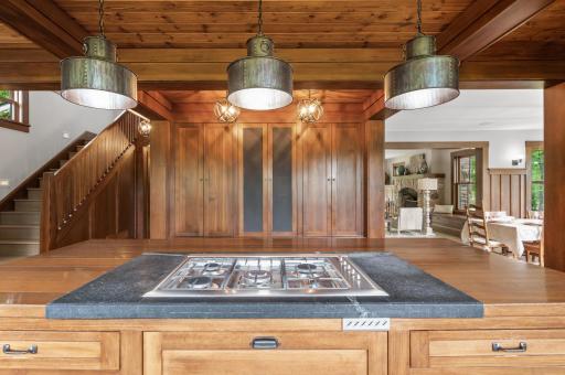 The kitchen features a Fisher and Paykel gas-burning cooktop, offering precise and efficient cooking capabilities.