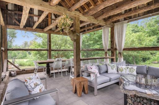 The outdoor living space includes a bar top, which serves as a focal point and a gathering area for socializing and entertainment.