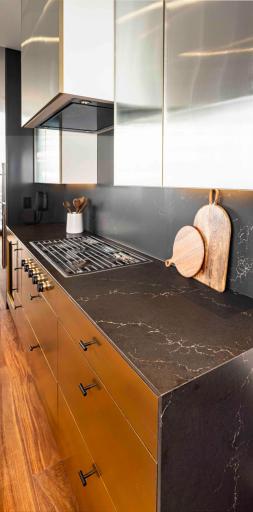 Modern Urban finish palette includes Cambria waterfall countertop, walnut wide plank flooring & trim. Photos courtesy of Cambria.