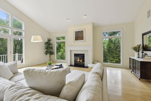 The great room features walls of windows to welcome in the sun and offer amazing views of the wooded setting.