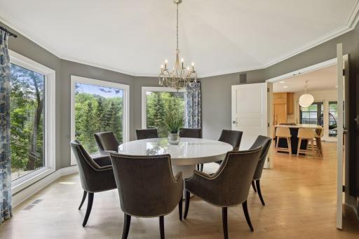 The elegant formal dining room will be the scene of many memorable events, from intimate candlelight dinners to festive holiday celebrations. Bright windows offer treetop and backyard views, and overhead lighting adds style and flair.