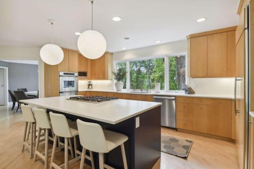 The hardwood floors add a classic look, and complement the lovely cabinetry and quartz countertops beautifully.