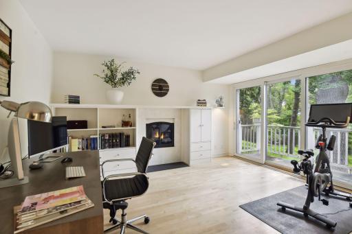 The office was renovated in 2020, and features hardwood floors, walls of built-ins, and sliders to a deck.