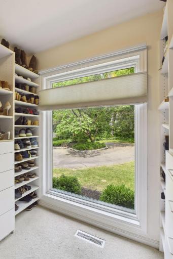 The walk-in closet is complete with loads of built-ins to organize your shoes and wardrobe.