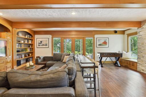 The family room is spacious and open, and walks out to the patio and lush back yard.