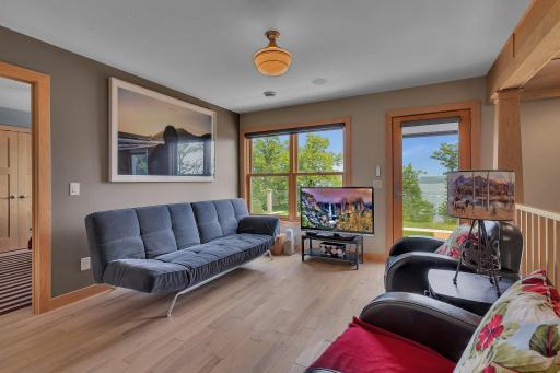 glass door leads to upper level sundeck with electronic awning
