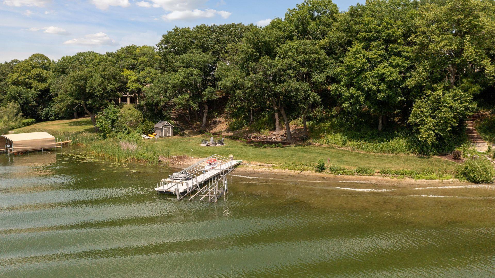 Close to 200 feet of level sandy grass and lake front area to enjoy. Hard sand lakefront with 2 shore stations, boat shed, dock and firepit