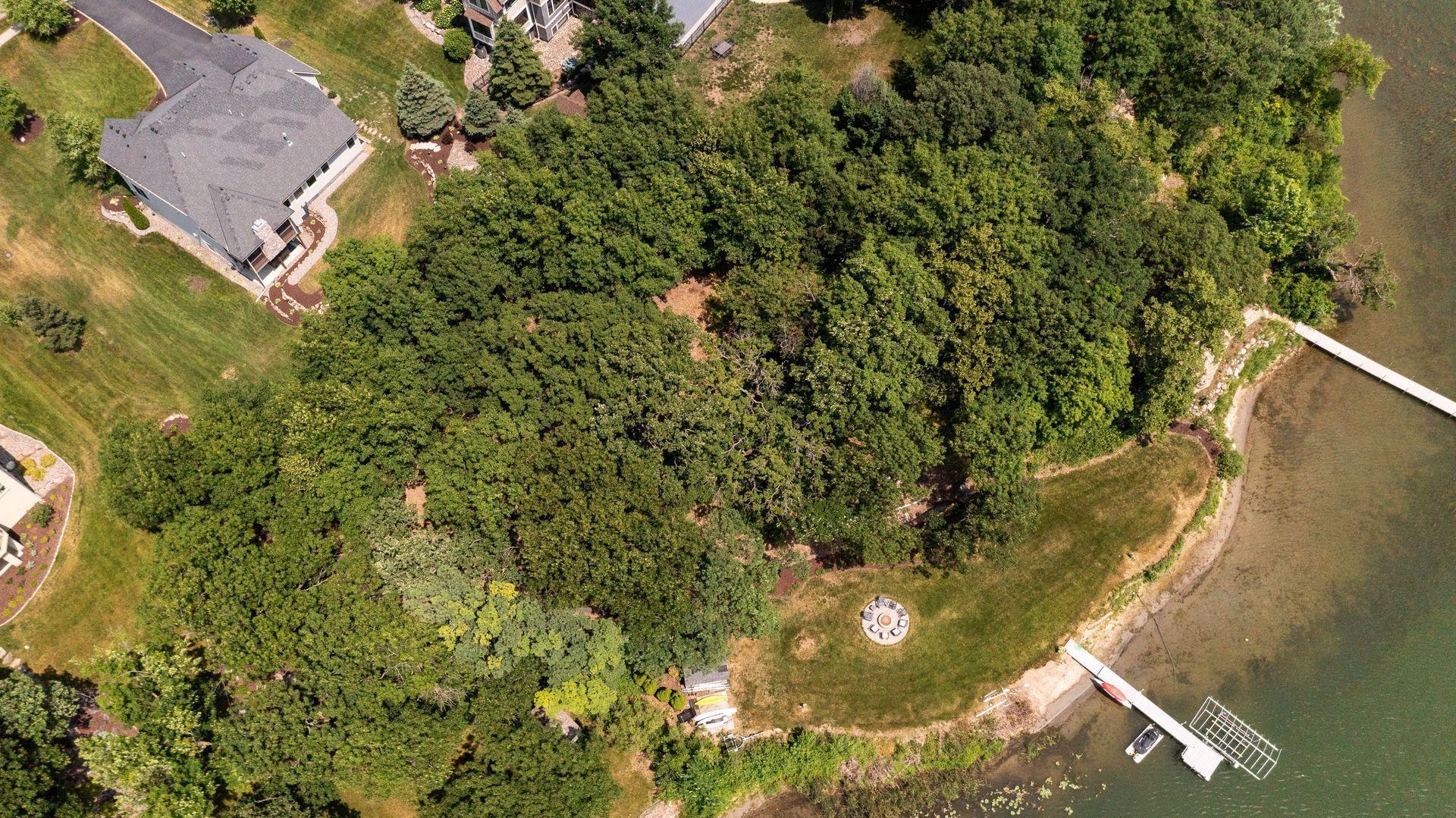 Aerial view of back of home, lot and lakefront