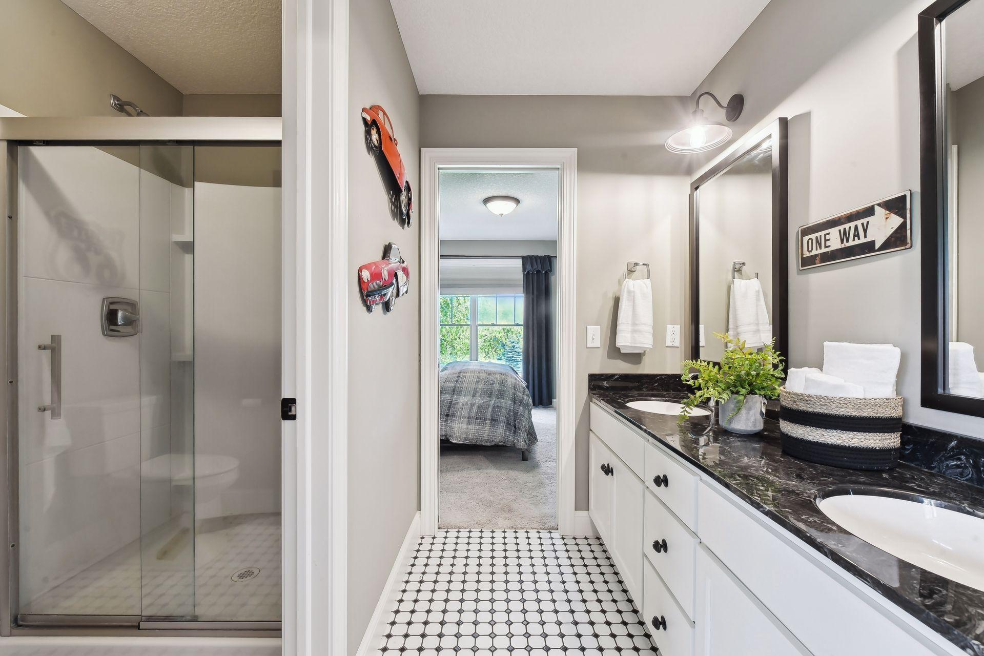 Awesome pass through bathroom with dual sinks, pocket doors and private stool area.