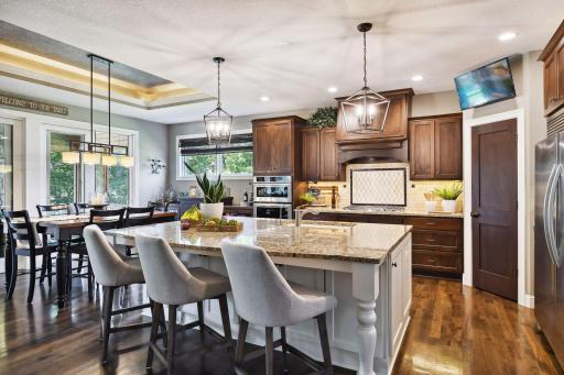 Beautiful kitchen with custom cabinetry and center island ideal for entertaining family or guests.