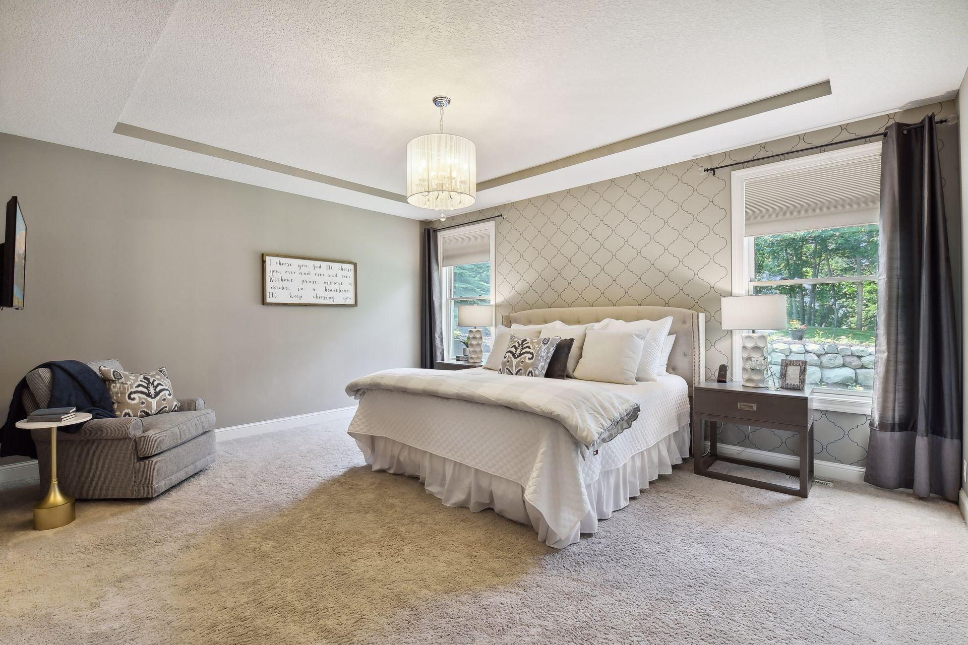 Welcome to the primary bedroom suite on the main with views of Lake Bavaria from your bedroom windows.