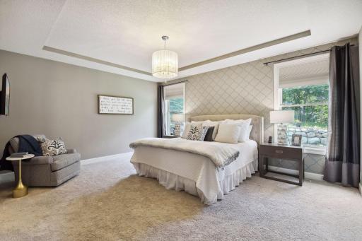 Welcome to the primary bedroom suite on the main with views of Lake Bavaria from your bedroom windows.