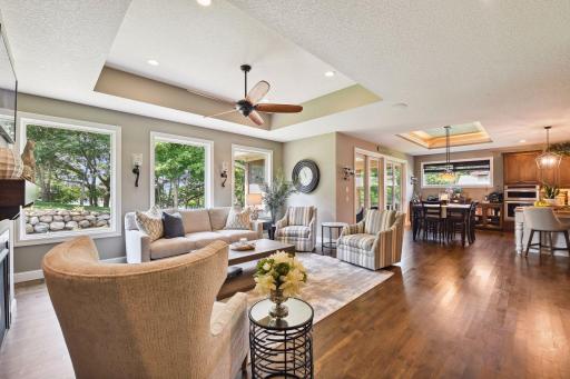 View from corner before entering ML primary bedroom. Open family room to kitchen and wall of windows to the backyard.