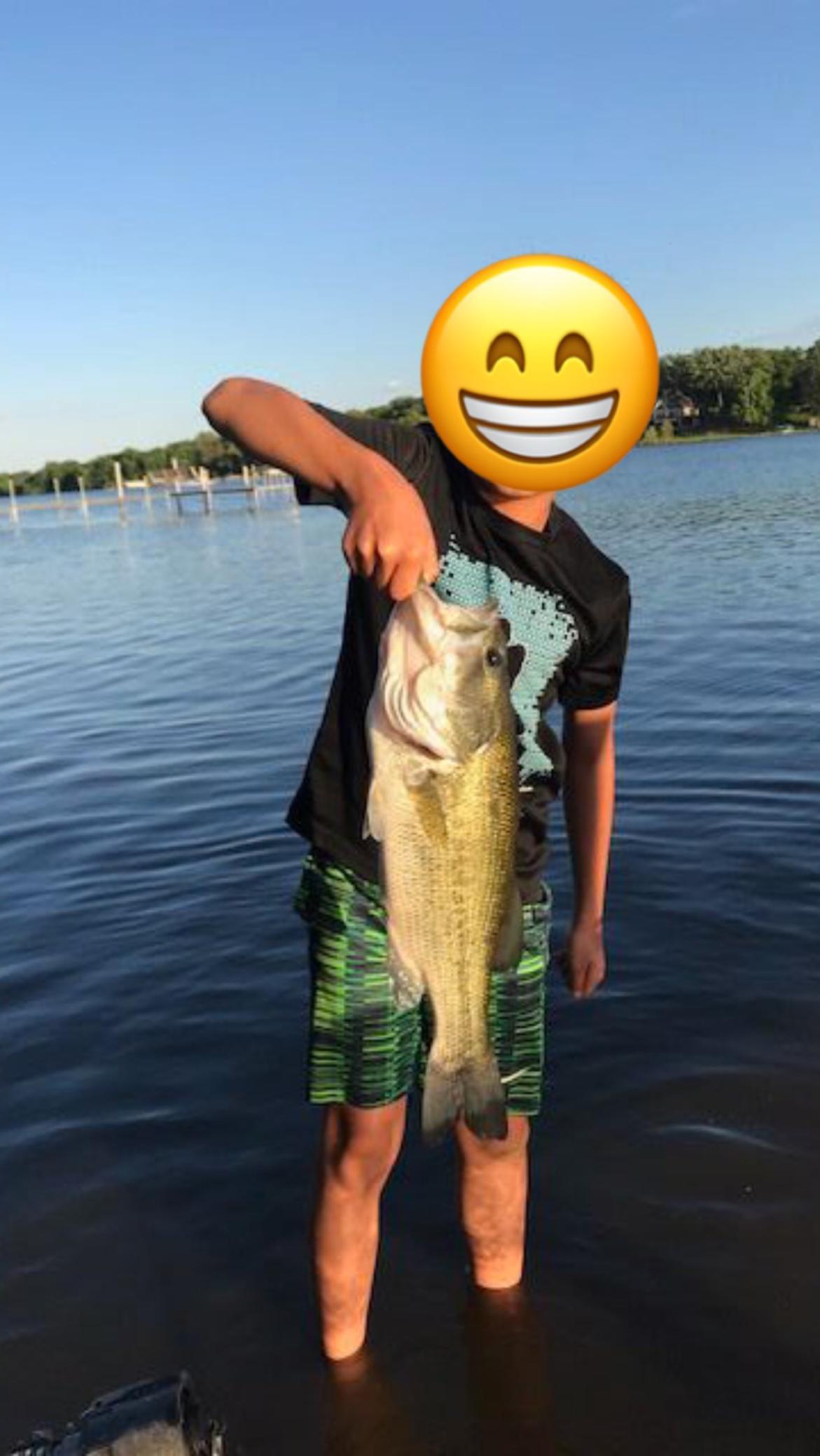 Huge Bass caught by son off their dock which drops off to 20 feet for ideal fishing.