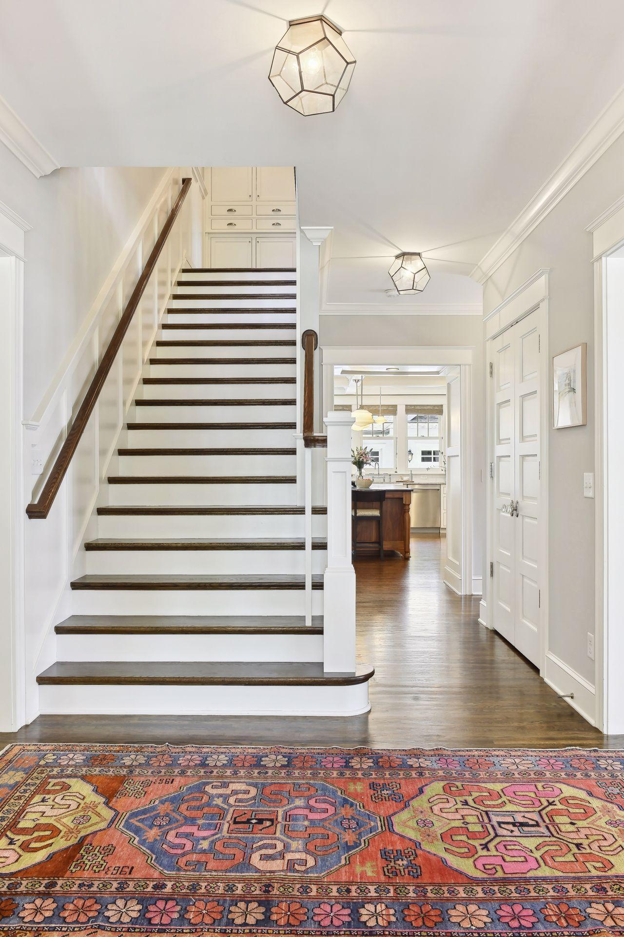 Wide staircase with classic lines, true to the vintage character of the many homes in the area