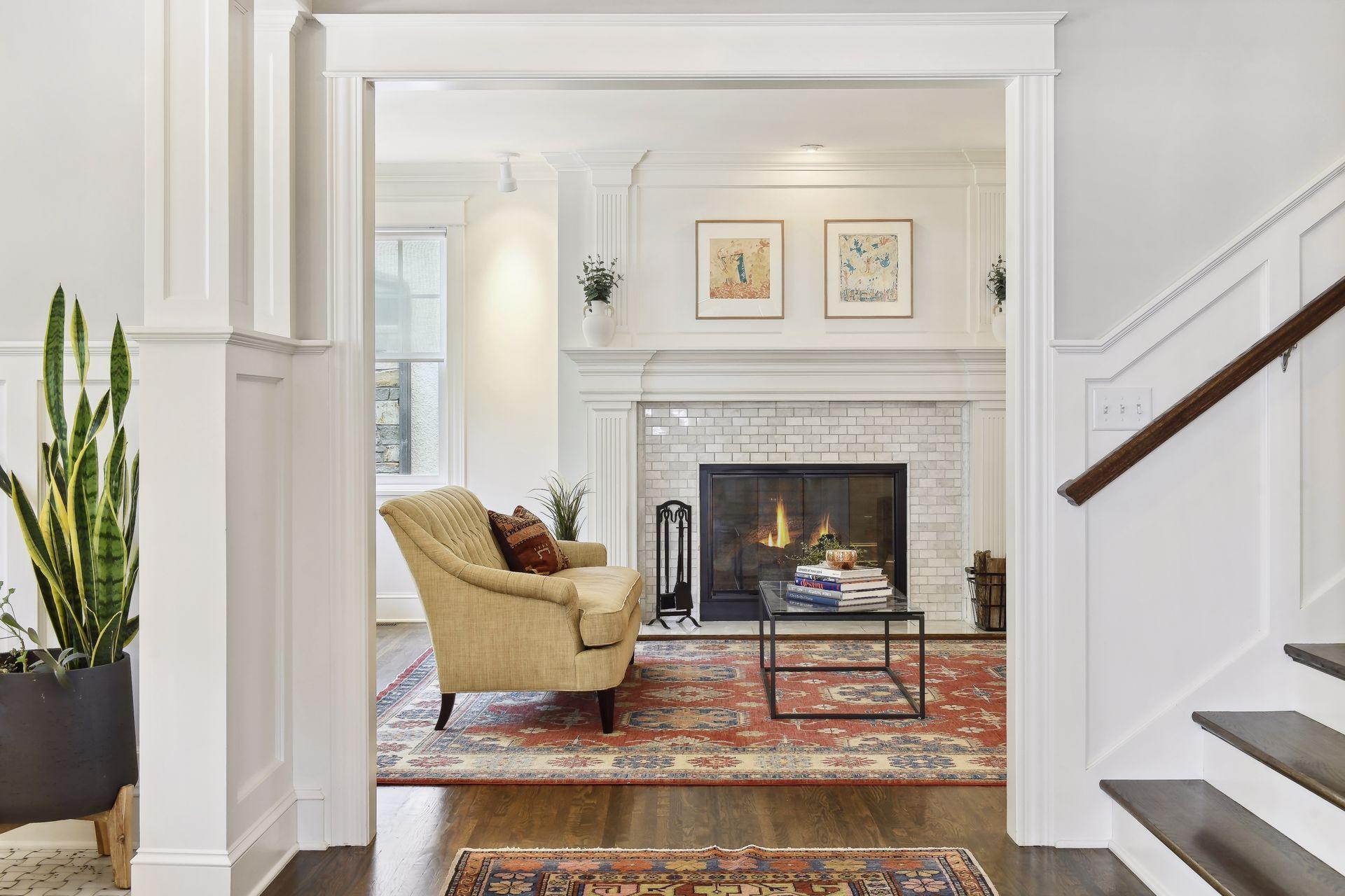 The lake facing front living room has a wood burning fireplace