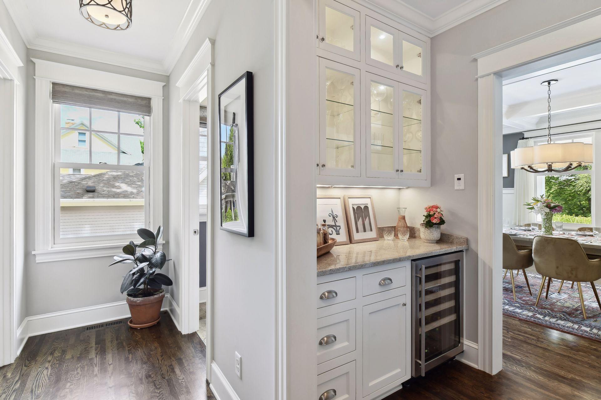 Butler's pantry with additional fridge and glass display shelves