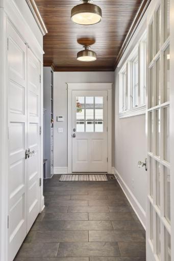 Spacious side entry mudroom with large closet and shelving for everyone