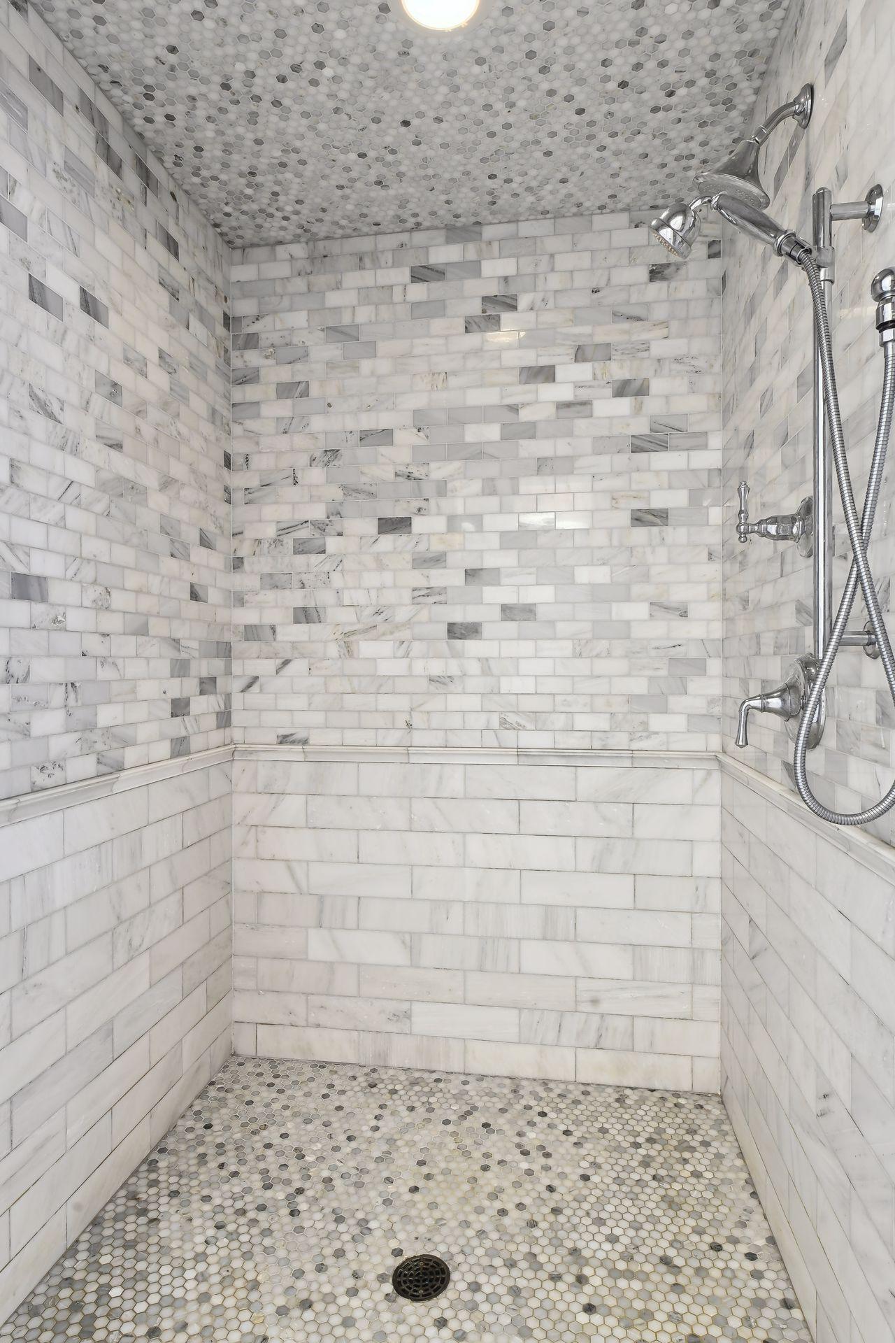 Large marble walk-in shower in the primary suite