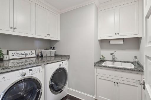 Second floor laundry room with sink