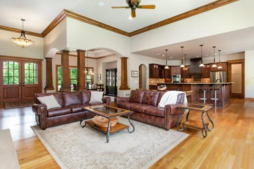 The architecturally designed great room with high ceilings and windows overlooks the huge private backyard.