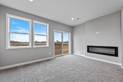 *Model Home - finishes may vary* This spacious family gathering area seamlessly connects to the kitchen area, perfect for entertaining. It also features many large windows providing warm natural light.