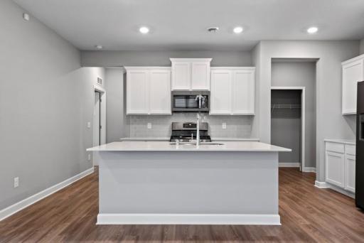 *Model Home - finishes may vary* Enjoy plenty of seating at the kitchen island and dining area adjacent to the kitchen. Perfect for entertaining or having a family meal together.