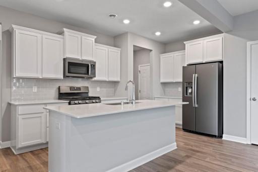 *Model Home- Finishes may vary* Thoughtfully-designed space with the perfect amount of natural light enhance the heart of the home. This kitchen offers a pantry, SS appliances, LVP flooring, and more!