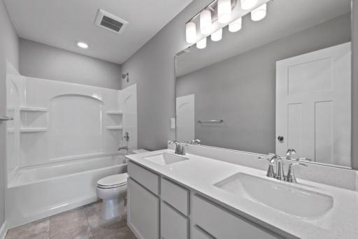 *Model Home - finishes may vary* The home's secondary bath features a double-vanity to help keep everyone moving during those busy mornings.