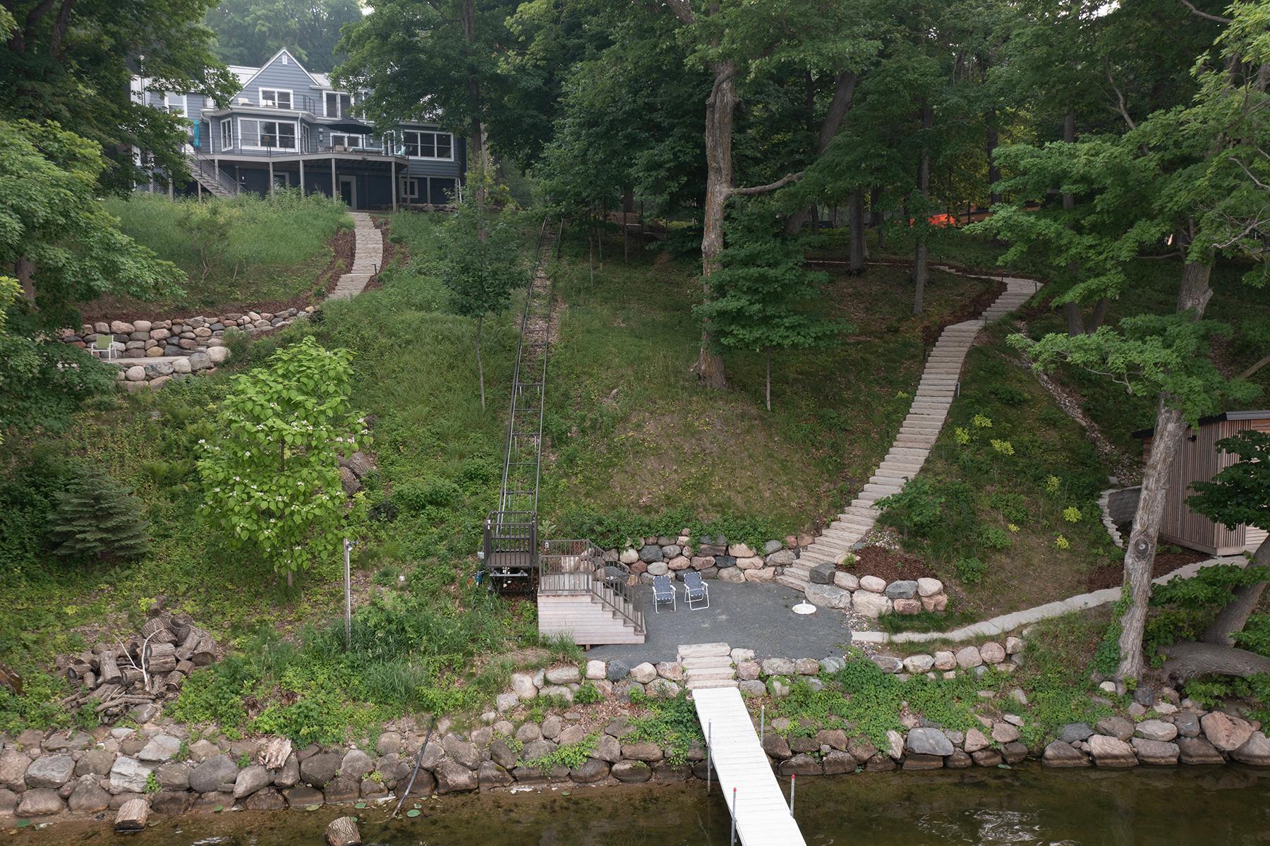 Time for Fun! Patio with Firepit, beautiful walk ways down to lake, take the newer tram to your dock, and boat house all to enjoy Lake Minnetonka!