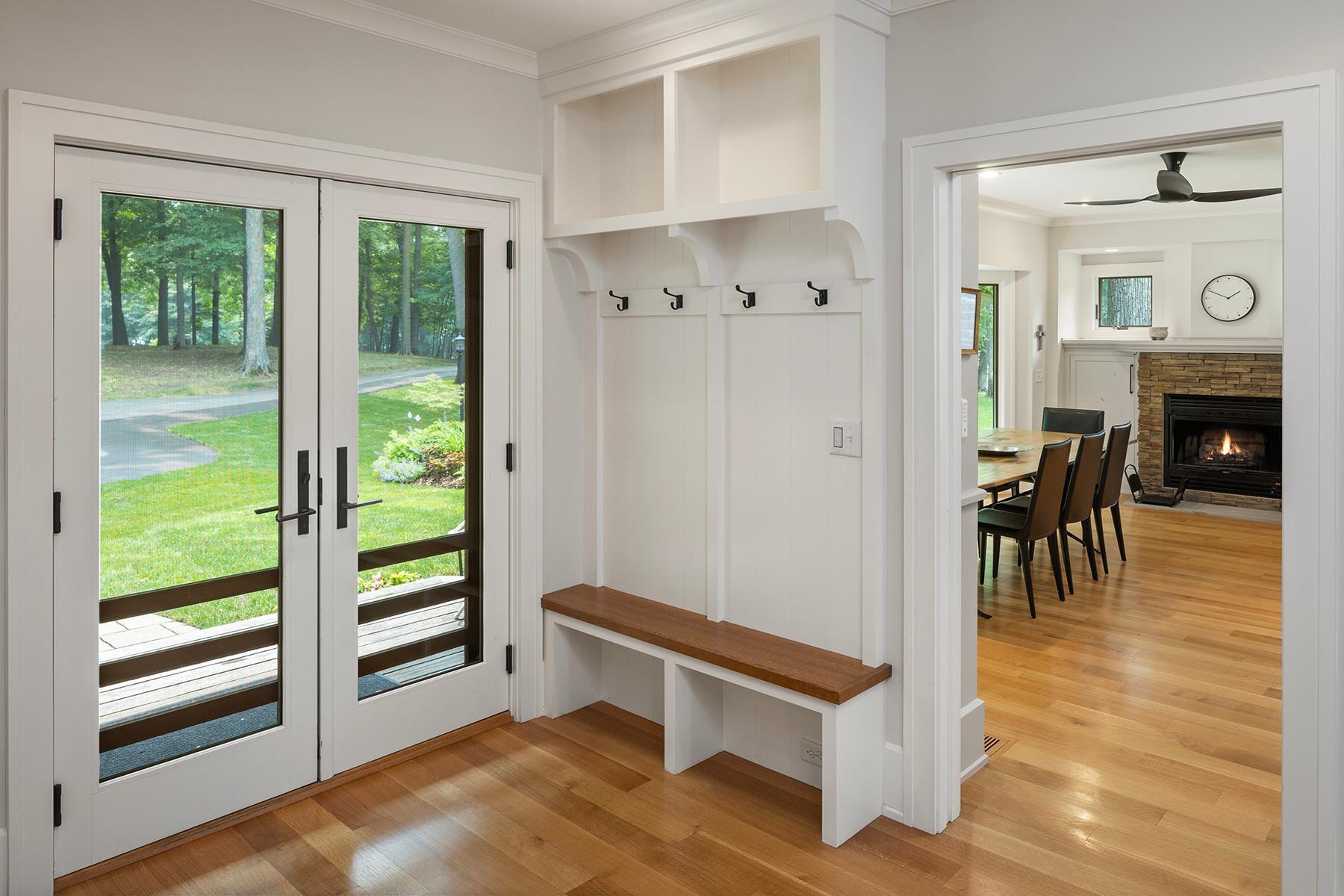 Wooded entry leads to foyer and kitchen