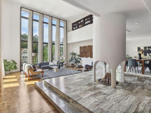 Raised travertine platform with four sided fireplace.