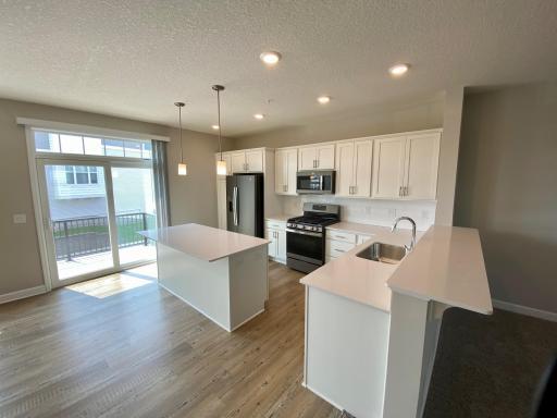 Beautiful kitchen with large center island and a breakfast bar.