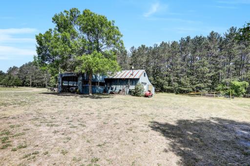 One owner home- this was the first workshop. End capped with 1 stall garages on both sides 14 x 24 each having loft above. One side is insulated and has a wood burning stove.
