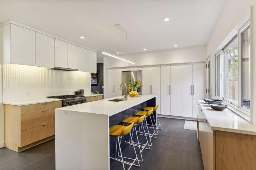 Sleek modern kitchen with quartz countertops, custom cabinetry and high end appliances.