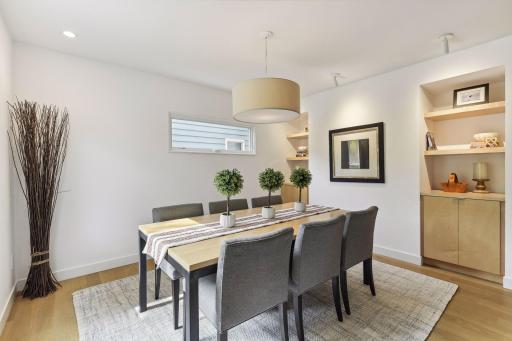 Formal dining room with built in cabinets and shelving.