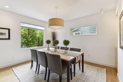 Beautiful white oak floors flow through the living and dining rooms and they shared two sided fireplace.